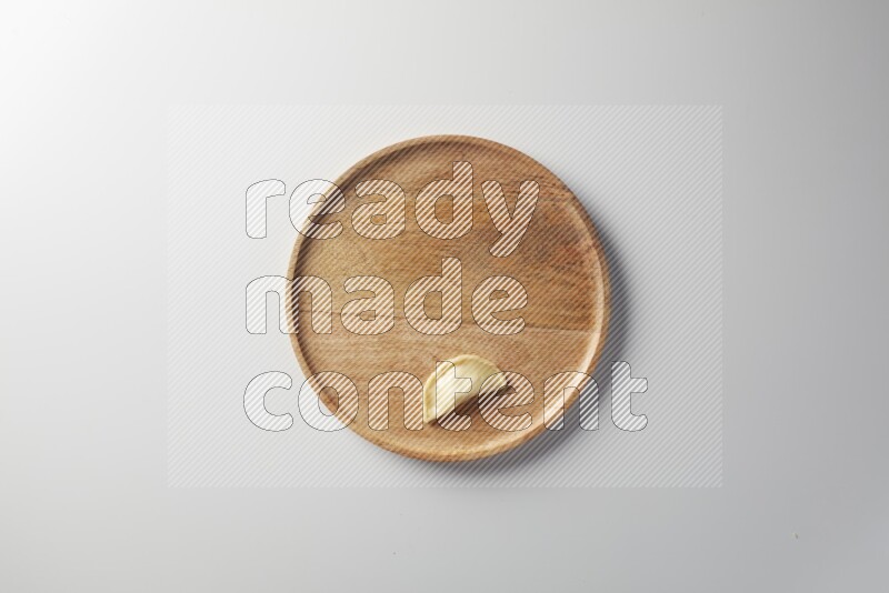 A single Sambosa on a wooden round plate on a white background