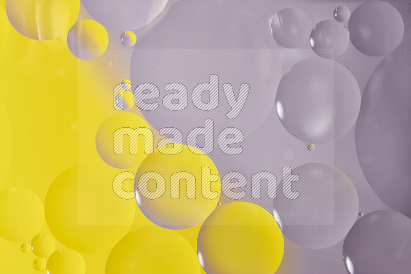 Close-ups of abstract oil bubbles on water surface in shades of white and yellow