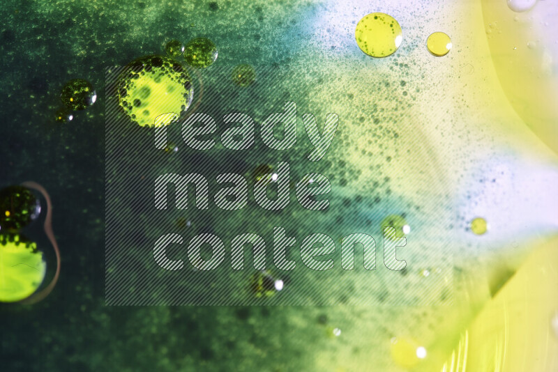 Close-ups of abstract green and yellow watercolor drops on oil Surface on white background