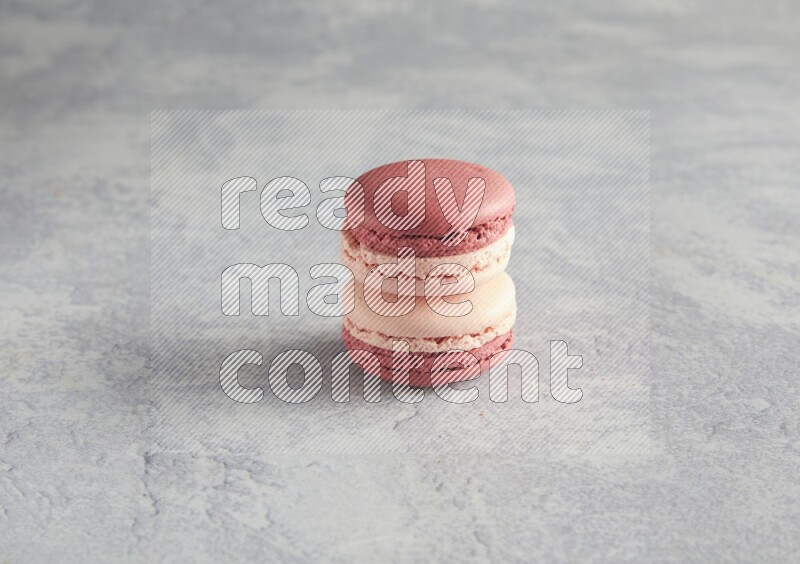 45º Shot of two Pink Litchi Raspberry macarons  on white  marble background