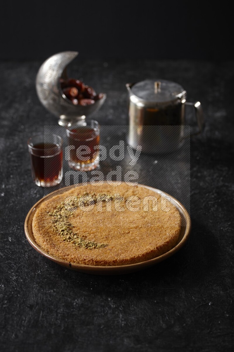 konafa with tea in a dark setup