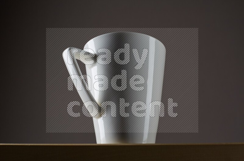 Low angle shot of a white cup on grey background