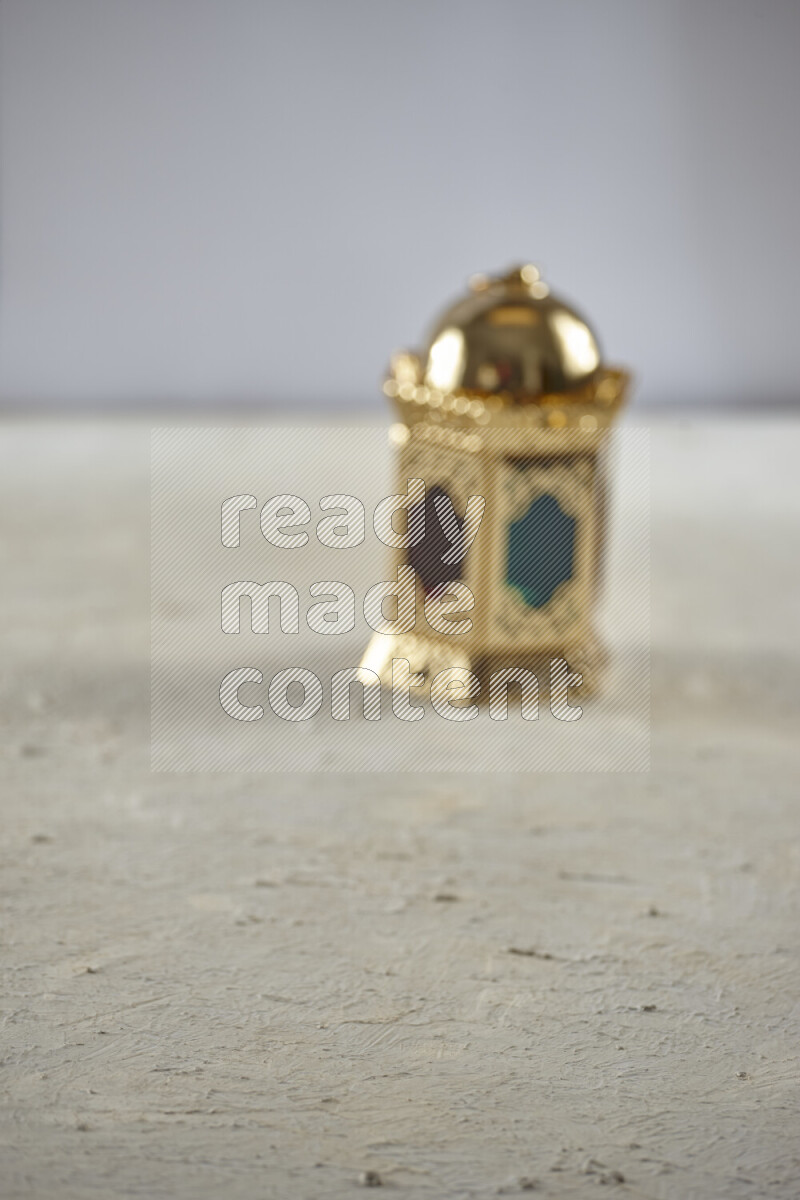 A lantern placed on a textured white background