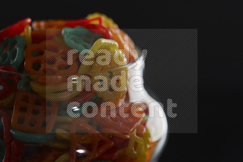 Snacks in a glass jar on black background
