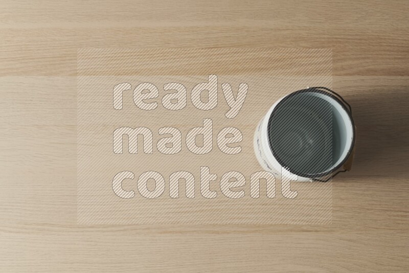 A vintage milk can on light wooden background