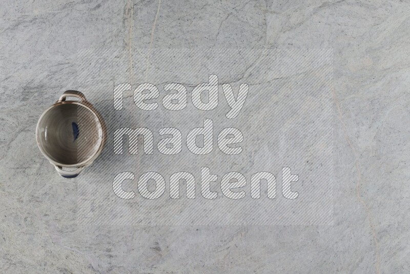 A multicolored pottery Bowl on grey marble background
