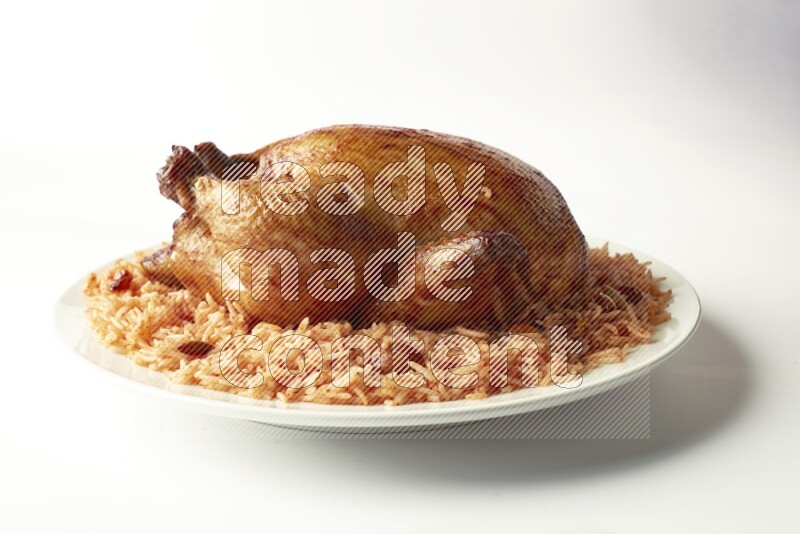 red basmati Rice with  whole roasted chicken on a white rounded plate  direct  on white background