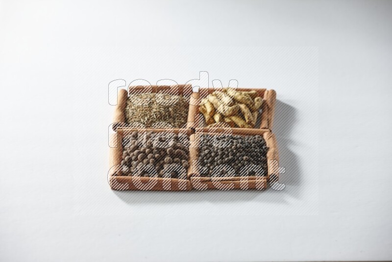 4 squares of cinnamon sticks full of cumin, turmeric fingers, allspice and black pepper on white flooring