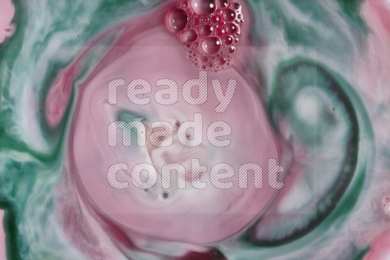 A close-up of abstract swirling patterns in red and green