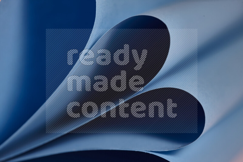 An abstract art showing blue paper sheets arranged in an overlapping curves