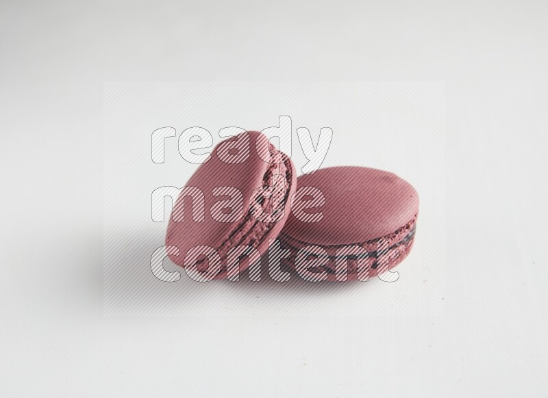 45º Shot of two Red Cherry macarons on white background