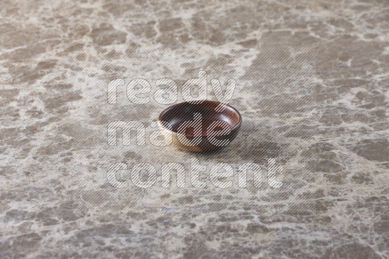 A wooden bowl on beige marble background