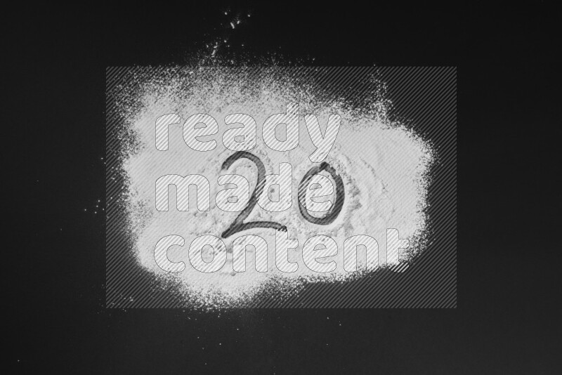 Numbers written with powder on black background