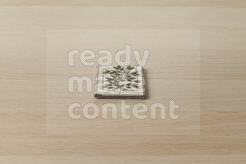 A decorative coaster on light wooden background