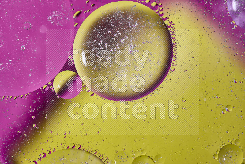 Close-ups of abstract oil bubbles on water surface in shades of yellow and pink