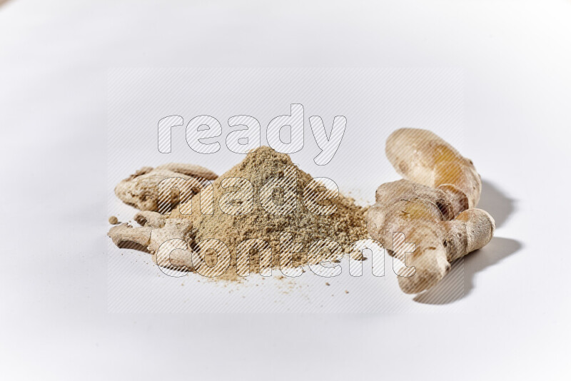 A bunch of ground ginger powder on white background