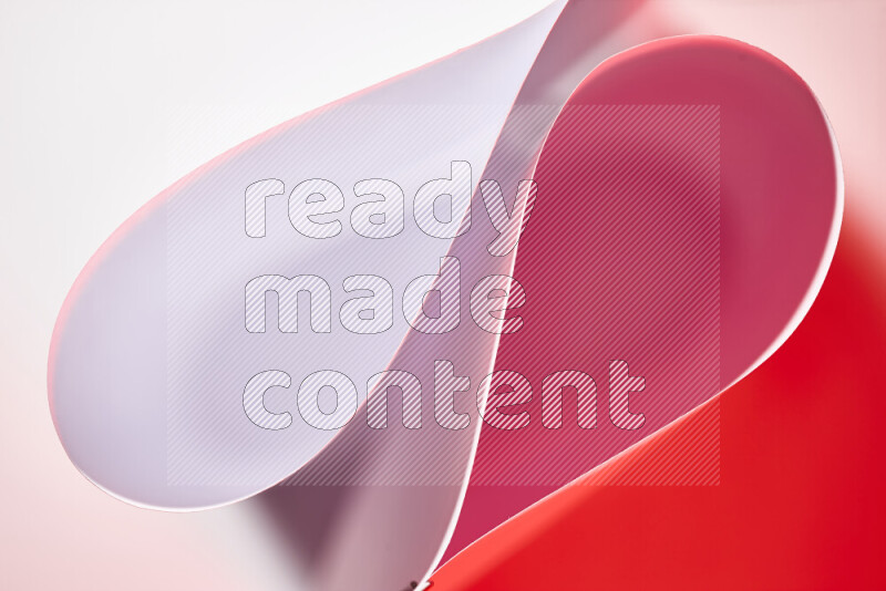 An abstract art of paper folded into smooth curves in white and red gradients