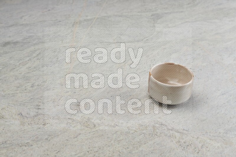 A multicolored pottery bowl on grey marble background