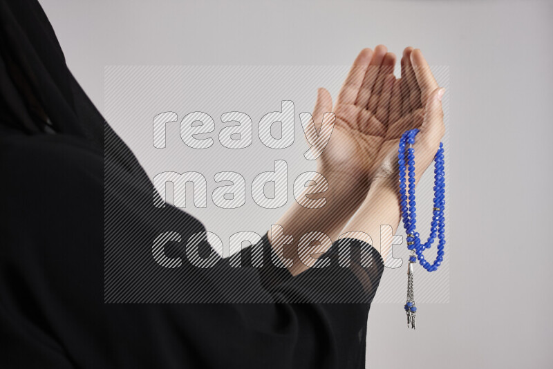 Woman hands holding praying beads (sebha) in different positions