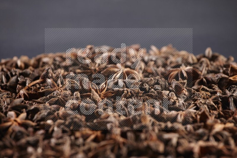 Star Anise herbs fill the frame on black flooring