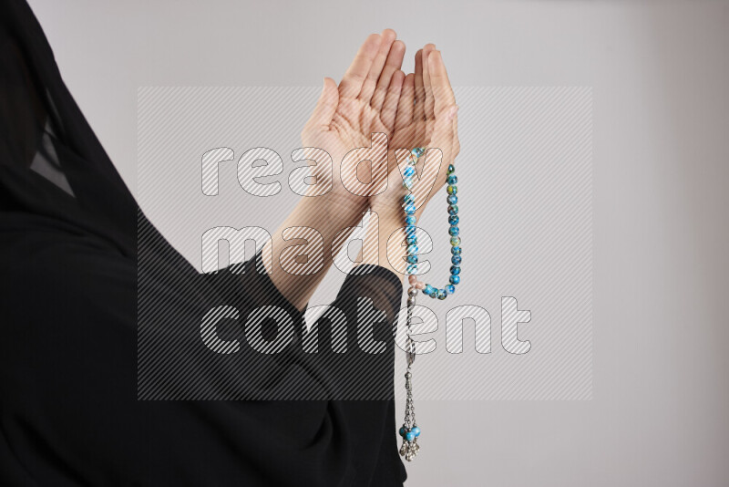Woman hands holding praying beads (sebha) in different positions