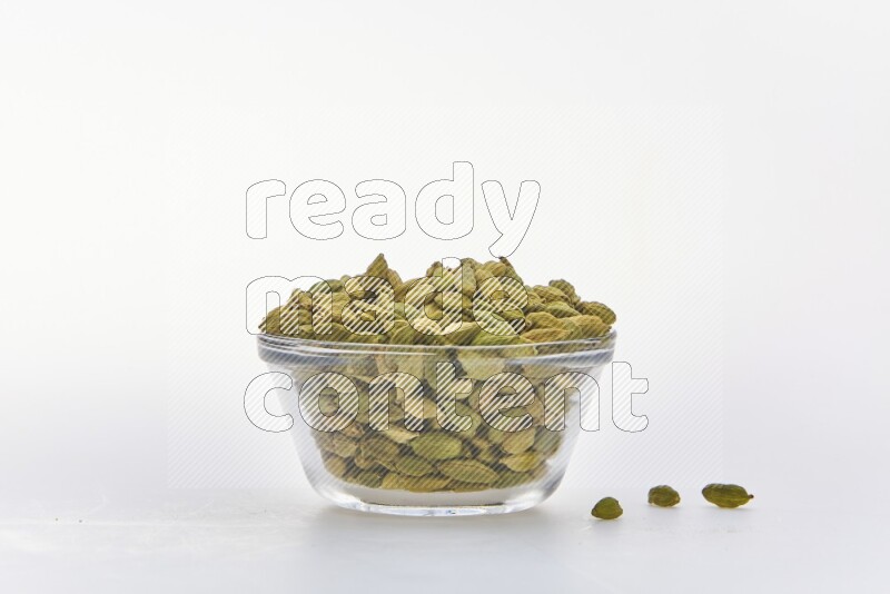 Cardamon in a container on white background