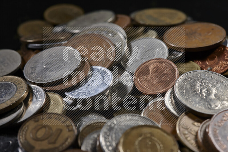 A close-ups of random old coins on black background