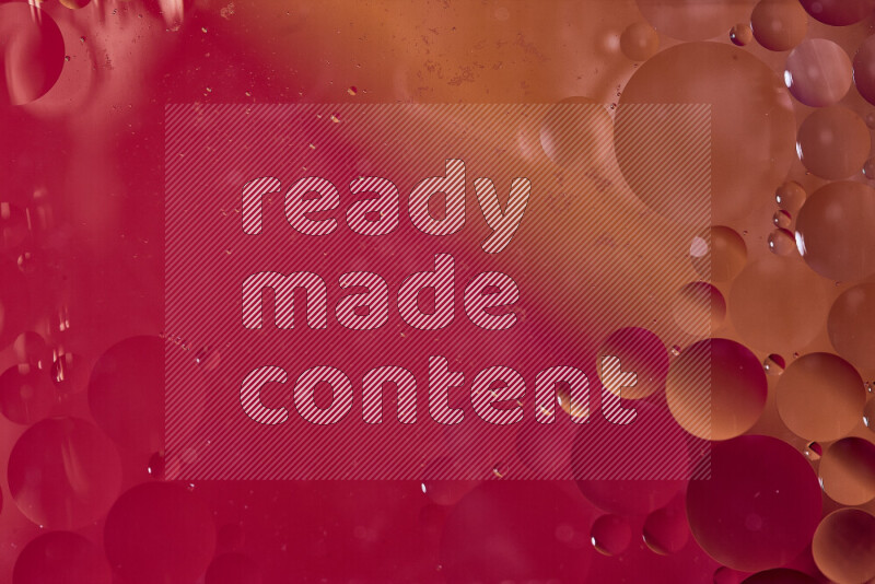 Close-ups of abstract oil bubbles on water surface in shades of red and orange