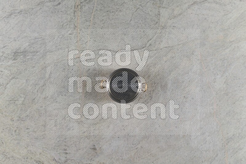 A small copper pot on grey marble background
