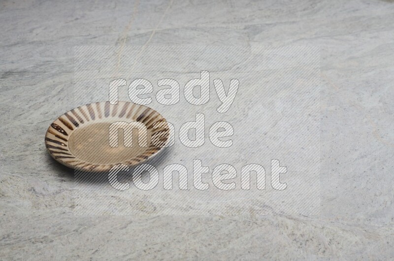 Multicolored Pottery Plate On Grey Marble Flooring