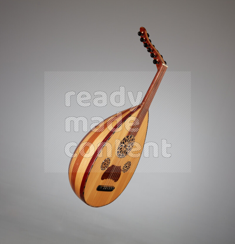a wooden brown Oud on a gray background