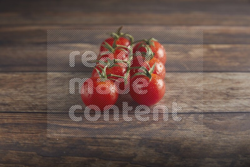 Red cherry tomato vein on a textured wooden background 45 degree