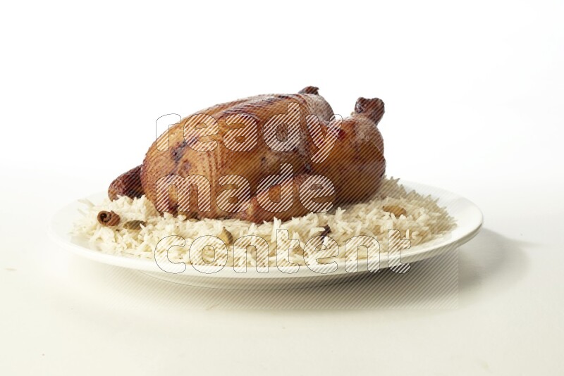 white  basmati Rice with  whole roasted chicken  on a white rounded plate direct on white background