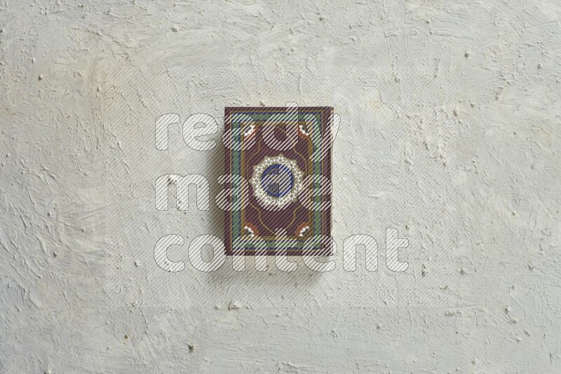 Quran with a prayer beads on white background