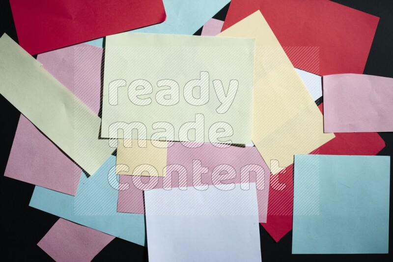Multicolored paper sheet on black background