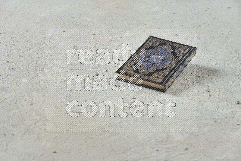Quran with a prayer beads on white background
