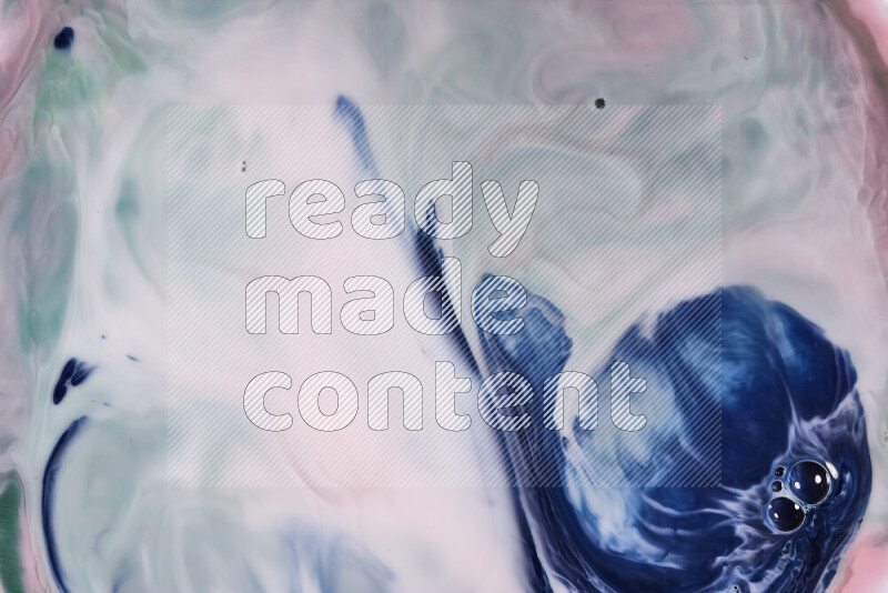 A close-up of abstract swirling patterns in red, green, white and blue