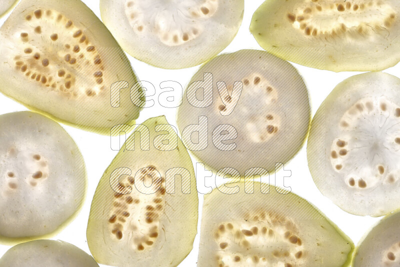Guava slices on illuminated white background