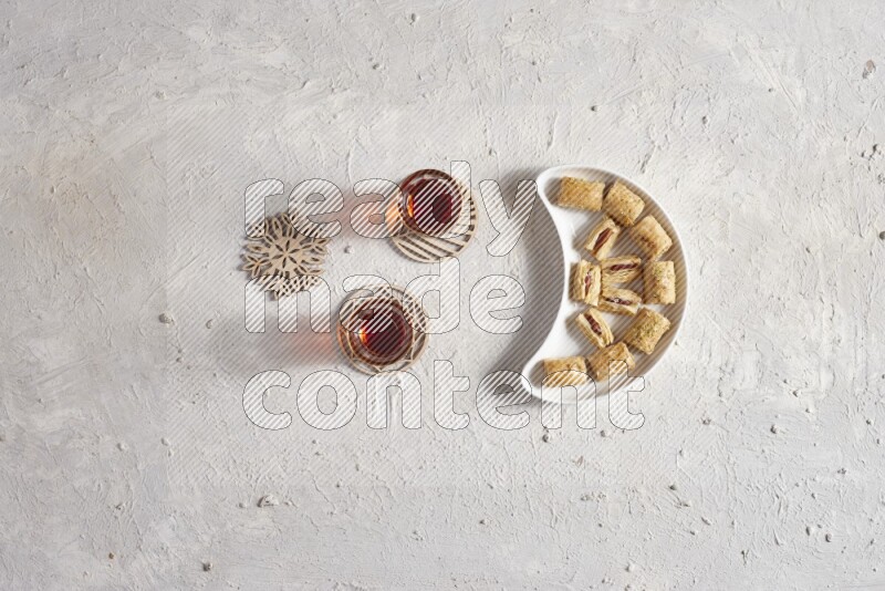 Oriental sweets in a pottery plate with drinks in a light setup