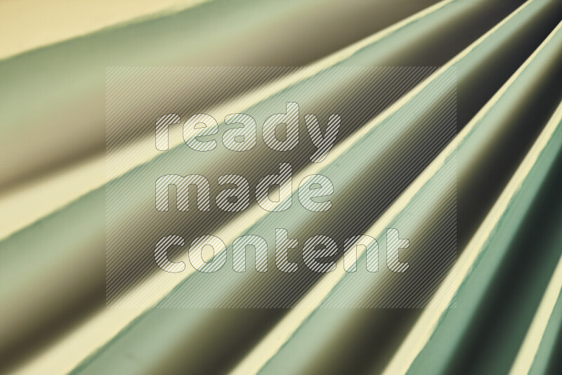 An image presenting an abstract paper pattern of lines in green and gold tones