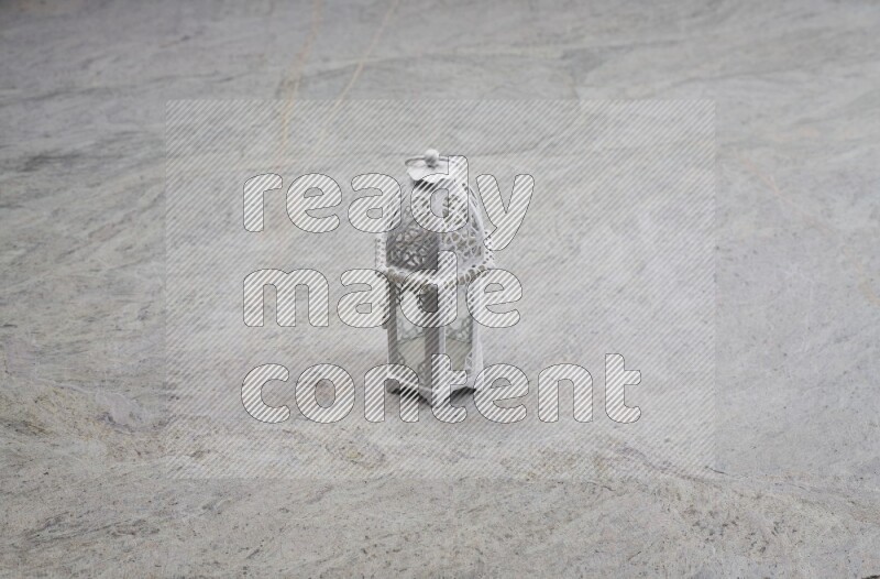 A candle lantern on grey marble background