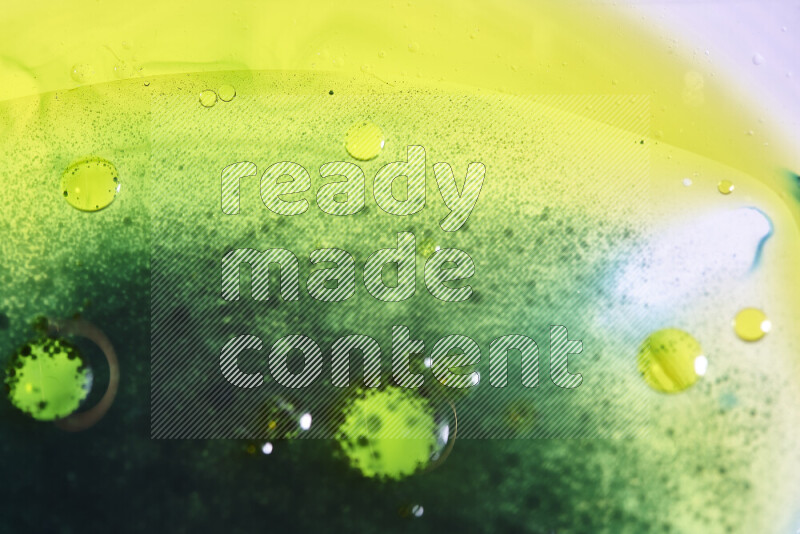 Close-ups of abstract green and yellow watercolor drops on oil Surface on white background
