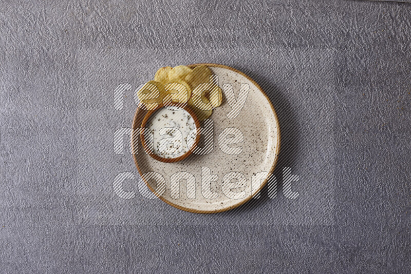 Assorted snacks in pottery bowls on grey background