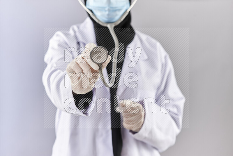 Female doctor wearing an abaya and medical attire in different positions