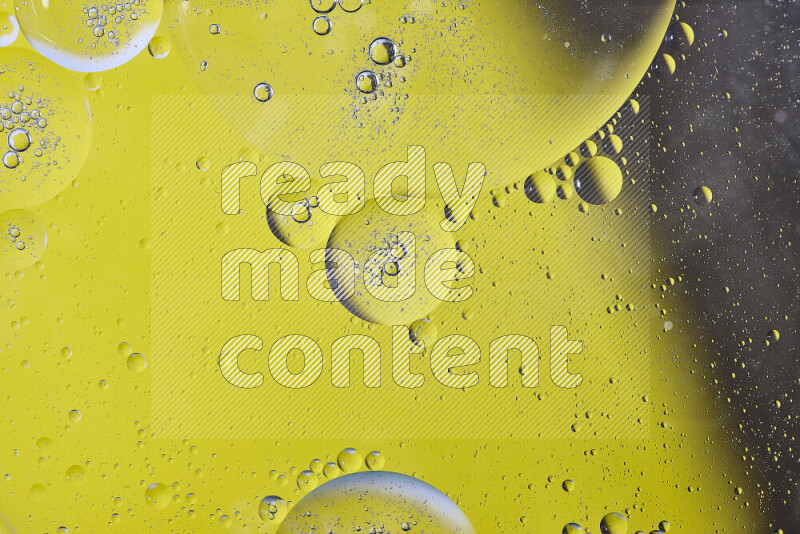 Close-ups of abstract oil bubbles on water surface in shades of yellow and brown