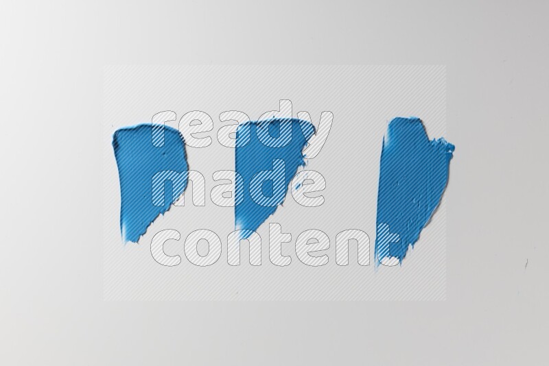 Blue painting knife strokes on a white background