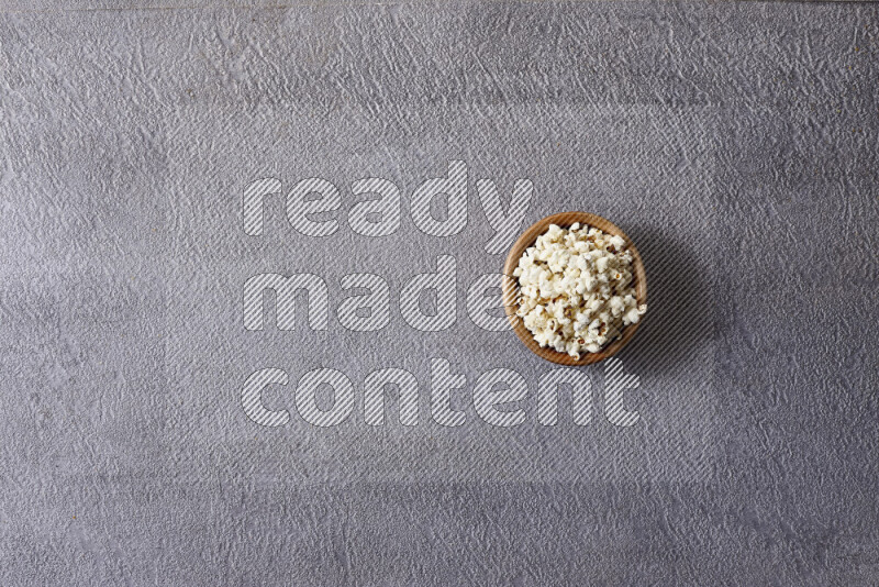 Assorted snacks in pottery bowls on grey background