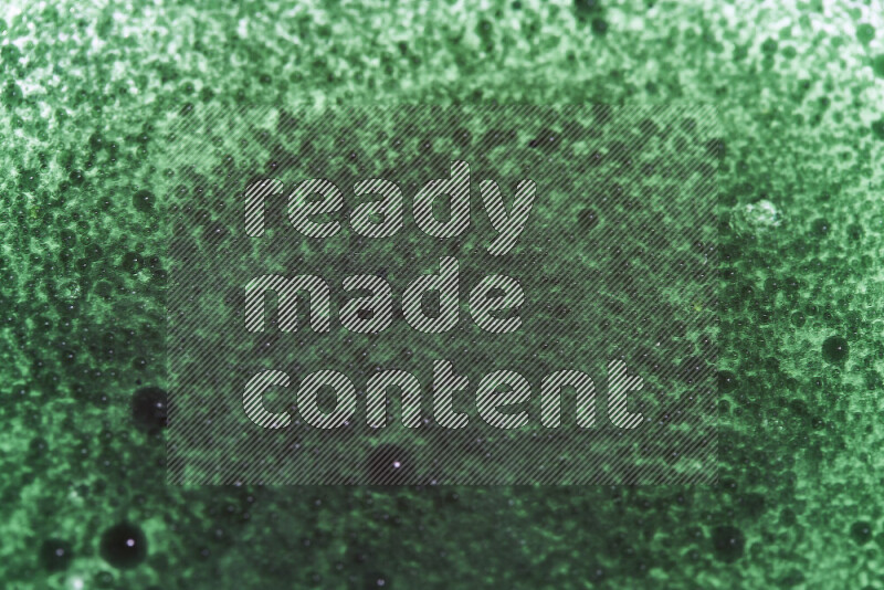 Close-ups of abstract green watercolor drops on oil Surface on white background