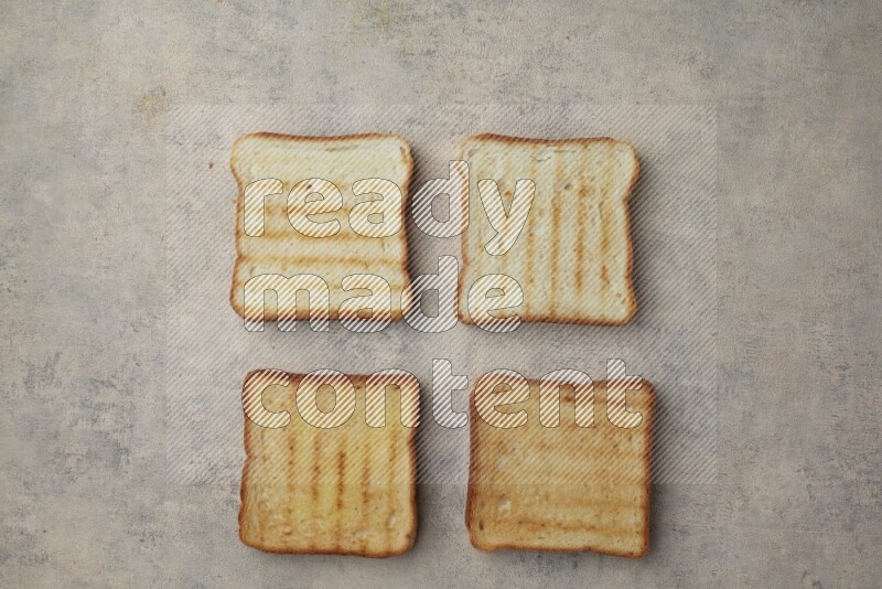 Toasted white Toast slices on a light blue textured background