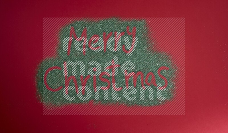 A sentence written with green glitter on red background